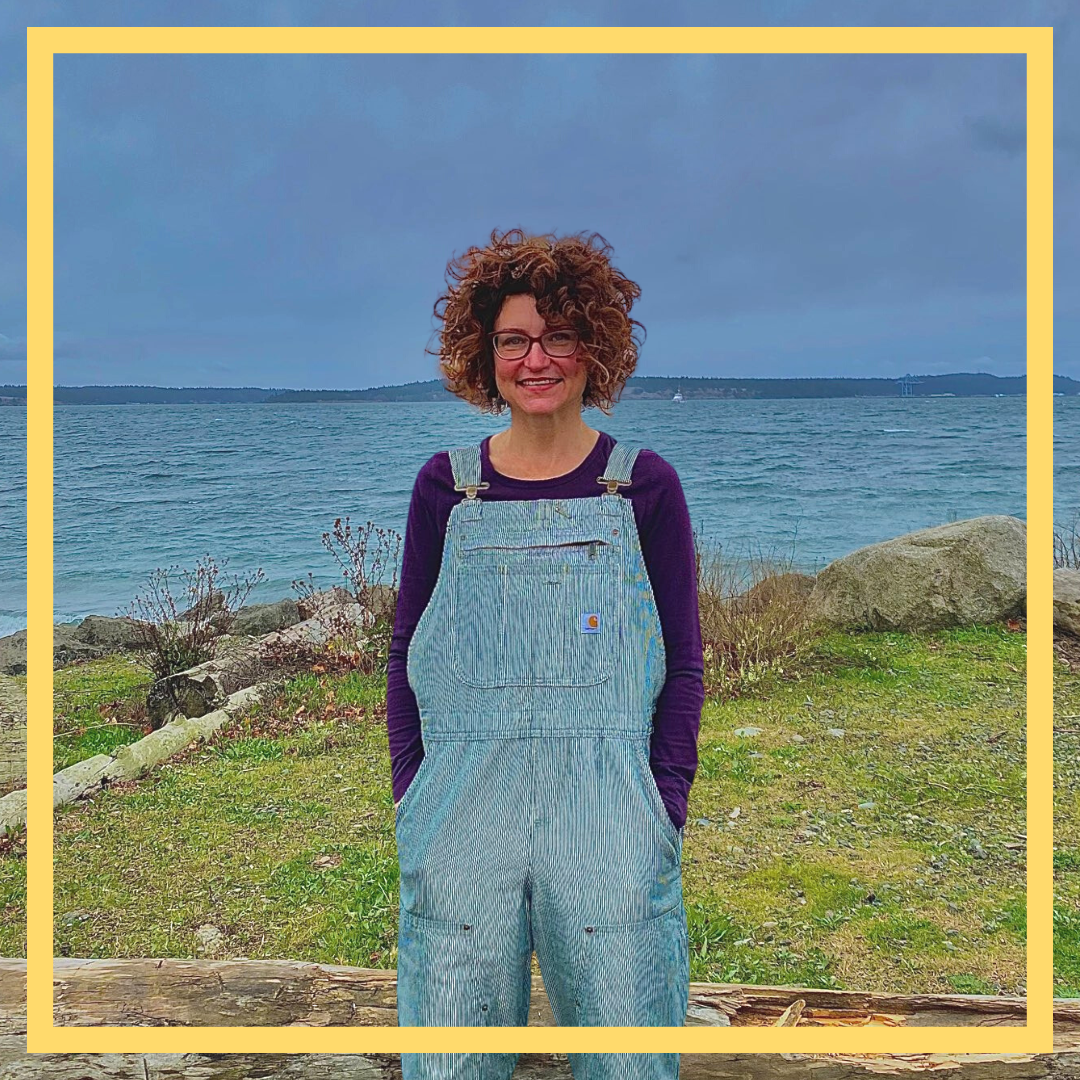 New team member Sarah N standing in front of the ocean.