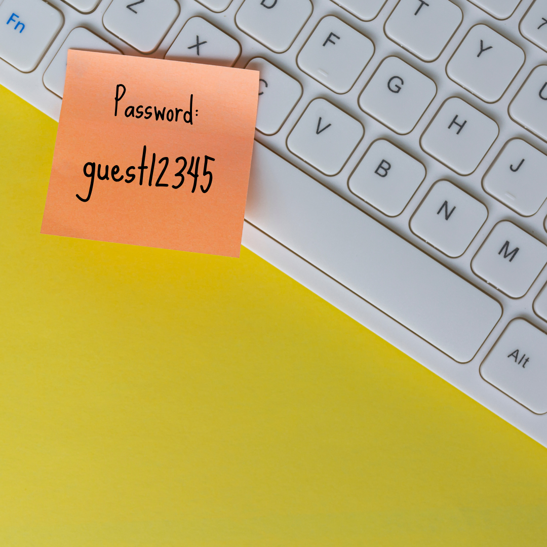 Flat lay of a keyboard with a post-it, saying the password is "guest12345." For the 200 most popular passwords of 2022. SpireTech.